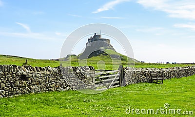 Lindisfarne Castle panoramic view, rock fence and wooden gate, Holy Island, Northumberland Stock Photo
