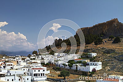 Lindos with the castle above on the Greek Island of Rhodes. Rhodes island - famous for historic landmarks and beautiful beaches Stock Photo