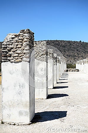 A line of ancient pillars and shadows from them Stock Photo