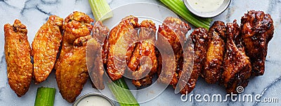 Line of buffalo chicken wings drenched in different sauces Stock Photo