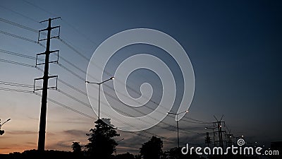 A line of electric tower, adjoin with street lamp on sunset Stock Photo
