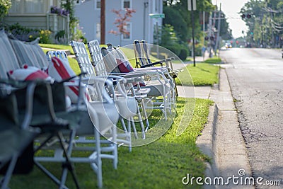 Line of empty chairs set up for fourth of July parade Stock Photo