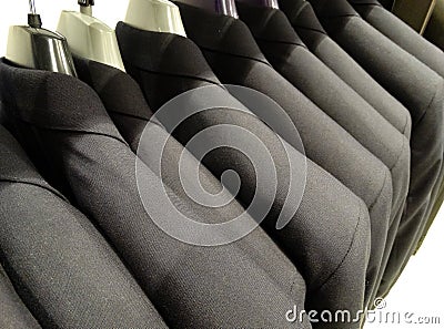 Line Of Grey Suit Jackets On Coat Hangers Stock Photo