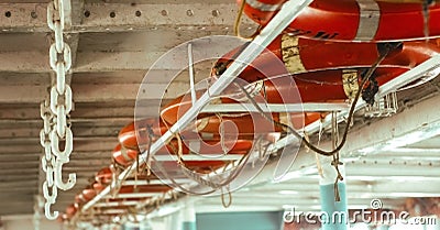 Line of lifebuoy ring floatation inside a traveler ship . Blurry background with copy space for text Stock Photo