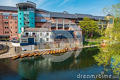 Line of moored rowing boats on the banks of River Wear near a boat club in Durham, United Kingdom on a beautiful spring afternoon Editorial Stock Photo