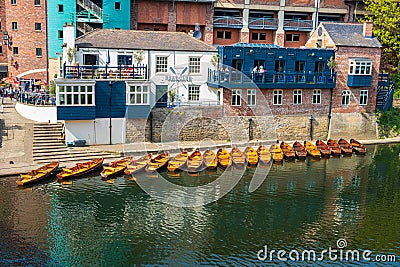 Line of moored rowing boats on the banks of River Wear near a boat club in Durham, United Kingdom on a beautiful spring afternoon Editorial Stock Photo