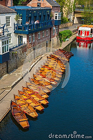 Line of moored rowing boats on the banks of River Wear near a boat club in Durham, United Kingdom on a beautiful spring afternoon Editorial Stock Photo