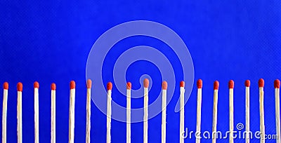 Line of seventeen red unused safety matches Stock Photo