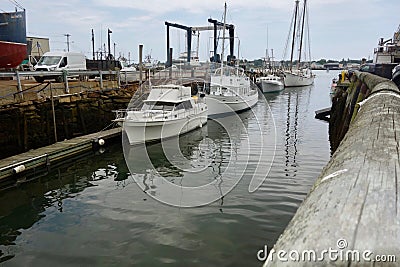Line of white leisure boats docked along Holyoke Wharf, Portland, Maine, USA, August 8, 2018 Editorial Stock Photo