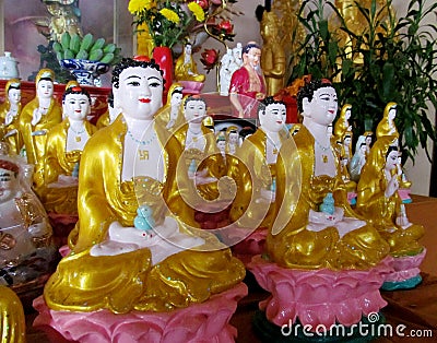 Line of yellow-dressed buddha statues Stock Photo