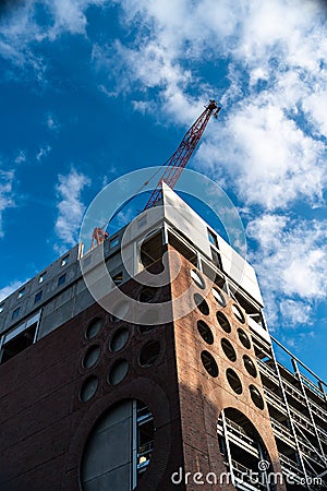 Linear geometric blue sky Crane building construction big urban red brick uk Stock Photo