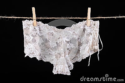 Linen drying on a string. Sexy women's panties pinned to a string Editorial Stock Photo