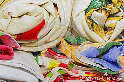 Linens rolled rolls piled stacks in a closet, cabinet furniture Stock Photo