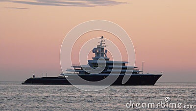 Liner in vastness of ocean at sunset Stock Photo