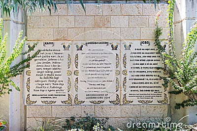 The lines from the Gospel of Mark in Karo, Luxembourgish and IGBO languages written on the wall in the Baptist place Yardenit, whe Editorial Stock Photo