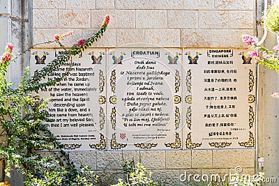 The lines from the Gospel of Mark in Nigerian, Croatian and Singapore Chinese languages written on the wall in the Baptist place Y Editorial Stock Photo