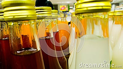 lines of several flavour of syrup bottles in supermarket Stock Photo
