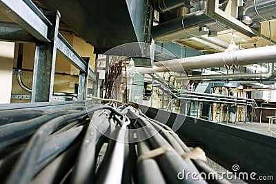 Lines of steel pipelines, wires and cables in a po Stock Photo