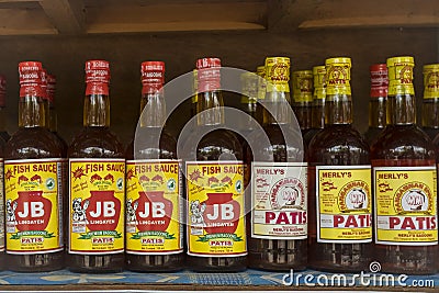 Lingayen, Pangasinan, Philippines - Bottles of locally made Patis or fish sauce for sale at a sidewalk stall Editorial Stock Photo