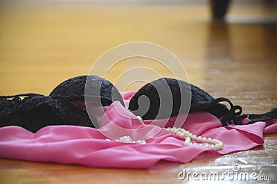 Lingerie and clothes thrown on the floor Stock Photo