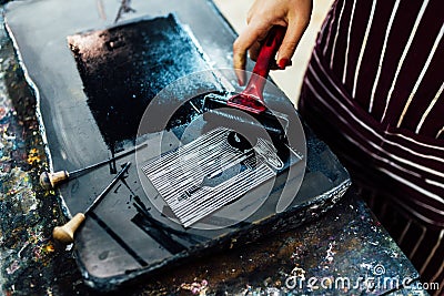 Linocut. rolling paint on a piece of linoleum Stock Photo