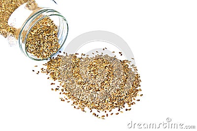 Linseed or Flex Seeds pouring from a glass jar Stock Photo