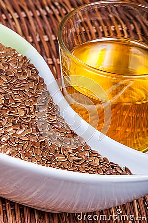 Linseeds (flax seeds) with linseed oil Stock Photo