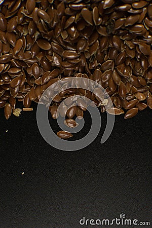 Brown Flax seed. Also known as Linseed, Flaxseed and Common Flax. Closeup of grains, background use Stock Photo