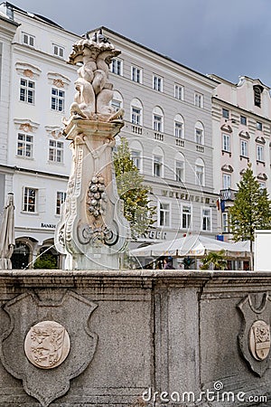Linz, Austria, 27 August 2021: Baroque Neptunbrunnen fountain with sculptures of dolphins, Hauptplatz or main square at sunny Editorial Stock Photo