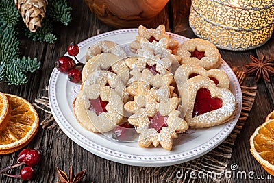 Linzer Christmas cookies arranged on a plate on a rustic background Stock Photo
