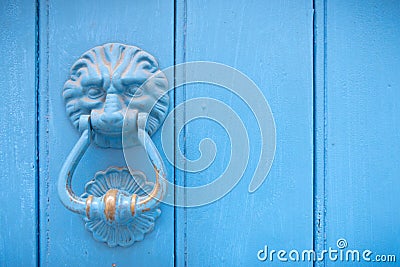 Lion head door knocker on an old wooden door Stock Photo