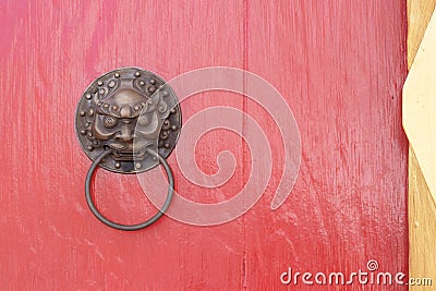 lion head door knocker at the red wooden door. Stock Photo