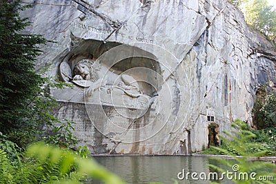 Lion of monument in Lucerne, Switzerland Inscription to commemorate for brave soldiers Editorial Stock Photo