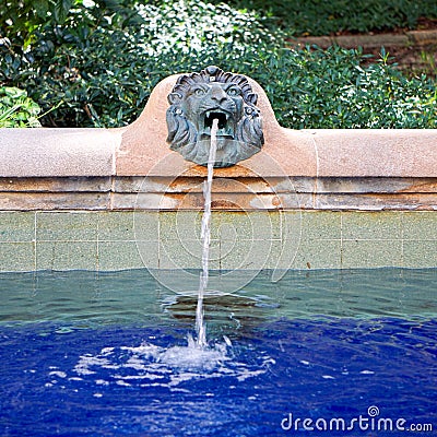Lions head fountain spurting water into pool Editorial Stock Photo