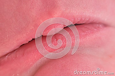 Lips on sad face of a newborn baby, close-up. Macro photo of a healthy child mouth Stock Photo