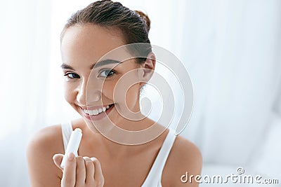 Lips Skin Care. Beautiful Woman Applying Lip Balm. Beauty Stock Photo