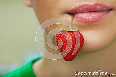 Lips with strawberry. Stock Photo