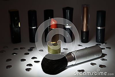 Lipstick and Make-up Brush, Spotlit Stock Photo