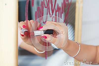 Lipstick writes on mirror Stock Photo