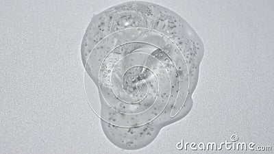 Close up shot of transparent substance on the white background. Cosmetic product gel or serum with bubbles on the Stock Photo