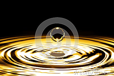 Liquid gold drop and ripple Stock Photo