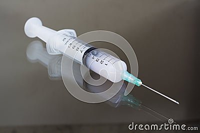 Liquid in the syringe on the table Stock Photo