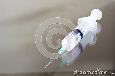 Liquid in the syringe on the table. Stock Photo