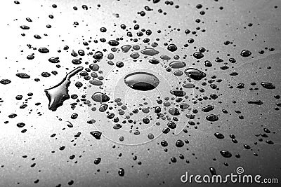 Liquid or water drops splash on the black or silver floor Stock Photo