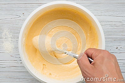 Liquid yellow pastry dough in bolw top view Stock Photo