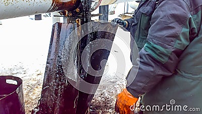 Liquidation of the oil spill. Locksmiths are engaged in eliminating oil leakage and repairing equipment. Workers liquidate the oil Stock Photo