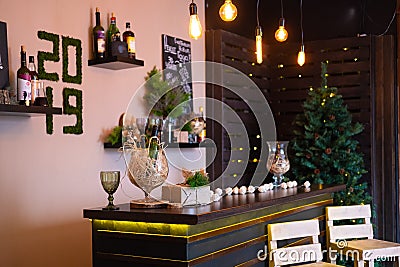 Liquor bar and many alcohol drinks behind the bar with vintage lamps. The inscription 2019 Stock Photo