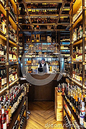 Liquor cellar inside the restaurant with sommerlier at cashier counter for help and giving information Editorial Stock Photo