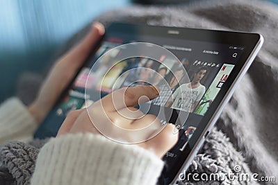 Woman choosing a netflix movie on tablet Editorial Stock Photo