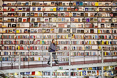 LISBON, PORTUGAL - 12 of December 2018 - Woman tourist in Bookshop Editorial Stock Photo